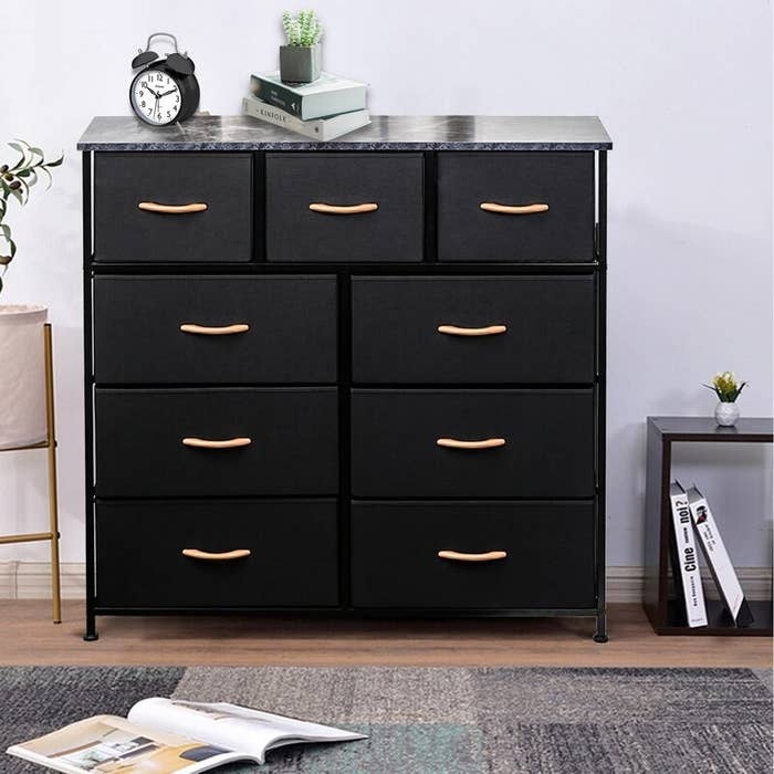 the black dresser with gold hardware