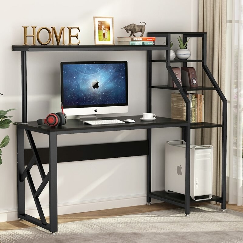 the black desk with a computer and accessories
