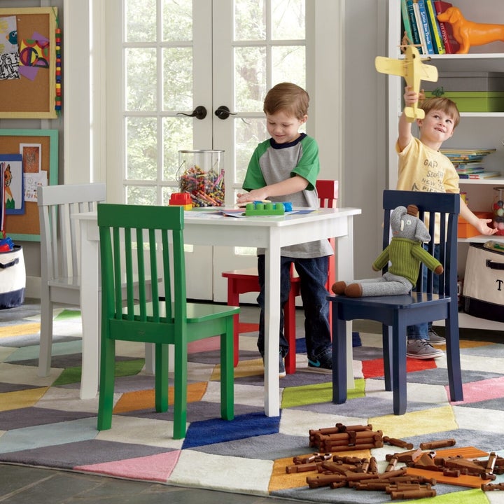 Image of model kids playing next to chairs