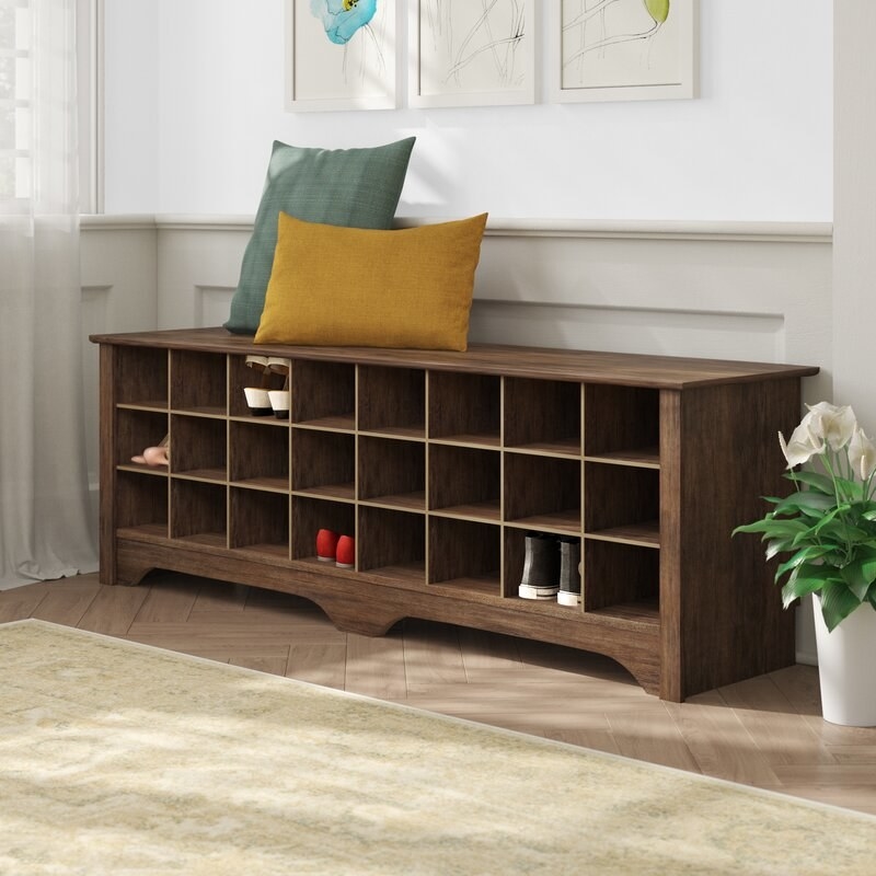 the brown bench with cubbies for shoes