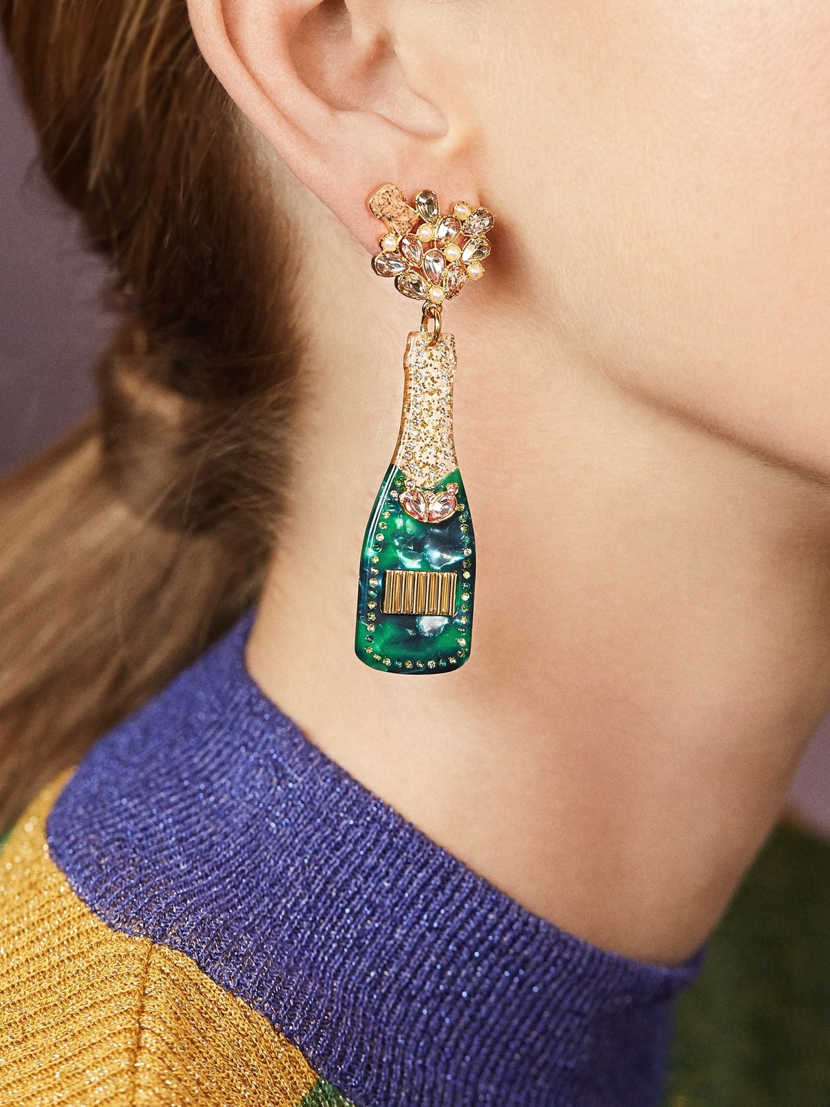 dangle earrings that look like a bottle of champagne with gems and a cork coming out of it