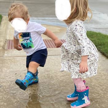Reviewer's children wearing the boots and splashing in puddles