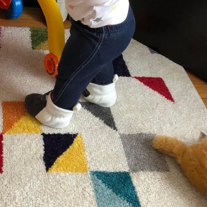 Reviewer's child wearing the booties in black and white