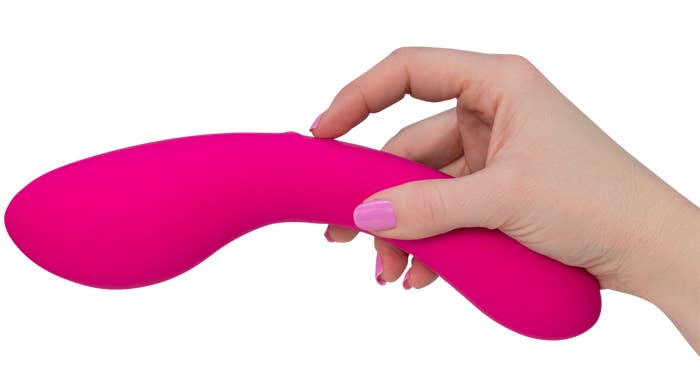 Model holding pink vibrator