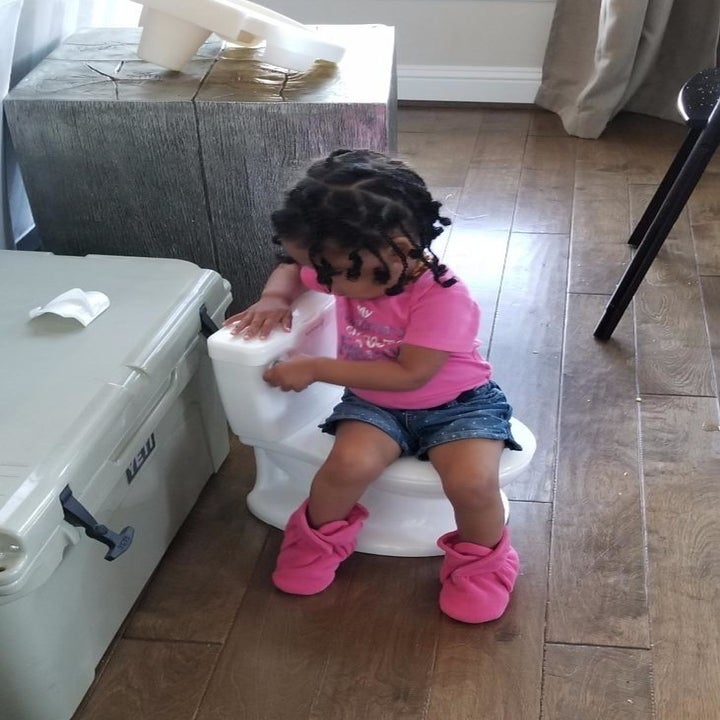 Reviewer's child wearing the booties in pink