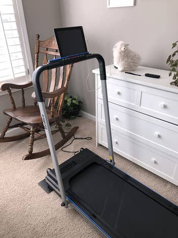 reviewer photo of the unfolded treadmill in a room