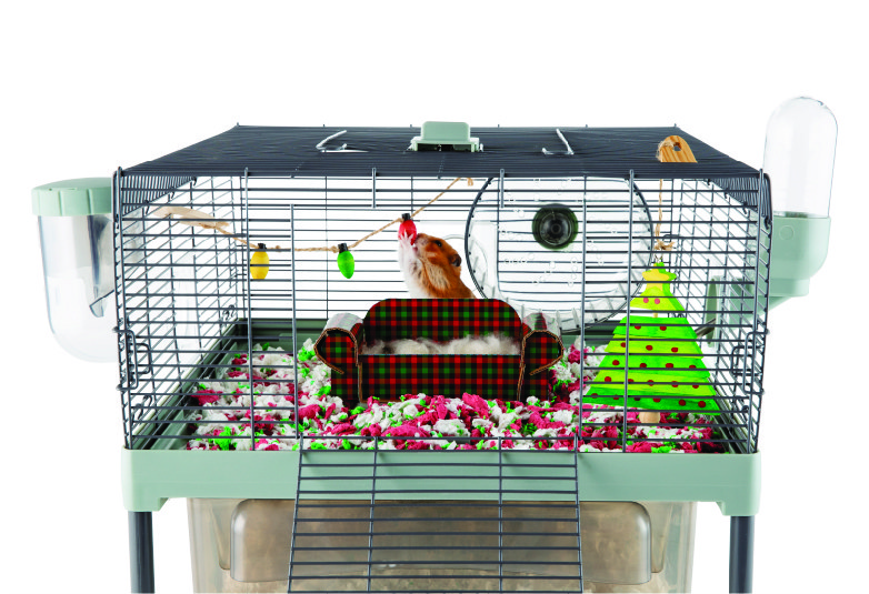 hamster cage that includes a plaid couch, christmas lights and a christmas tree as decorations