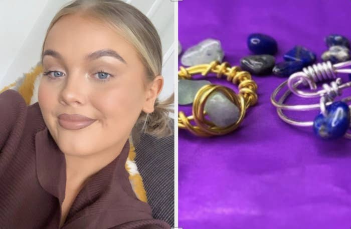 A business owner smiles next to handmade rings