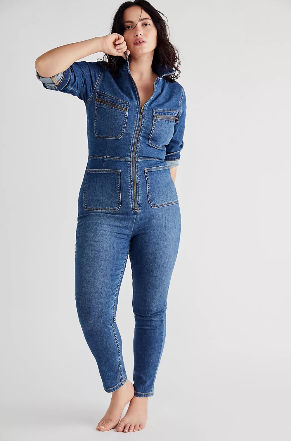 plus-sized model wearing the blue denim jumpsuit
