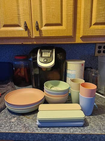 the entire set with big colorful plates on a kitchen countertop