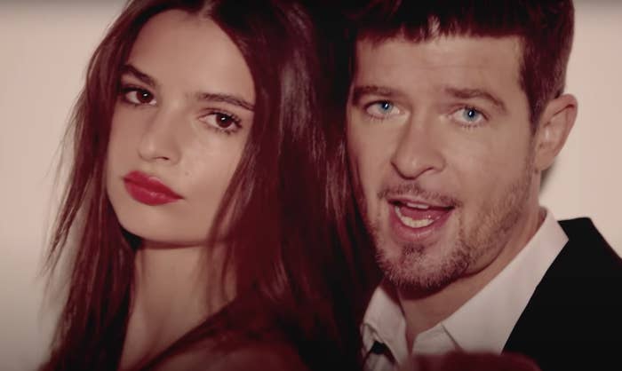 Emily leans against Robin in a closeup shot from the music video