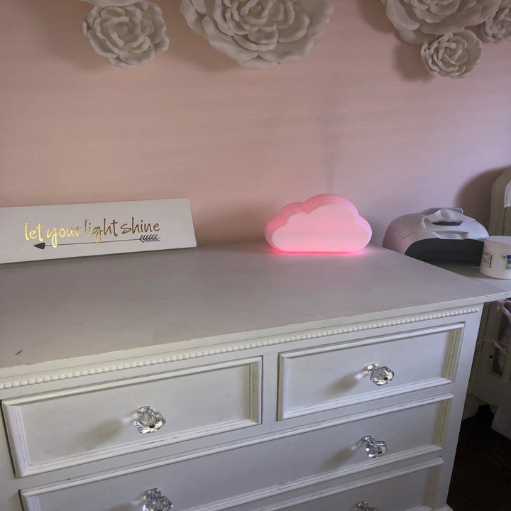 Reviewer's photo of the pink night light and humidifier in their child's nursery