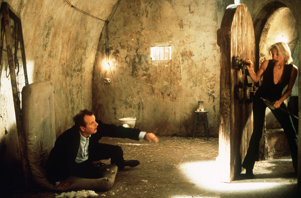 Bill Murray sitting on the ground as Cameron Diaz enters the room in a scene from the Charlie&#x27;s Angels