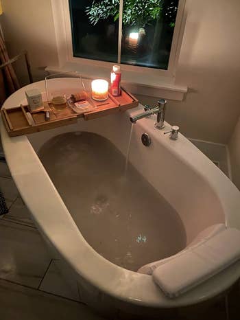 bathtub angle of pillow resting on edge of tub