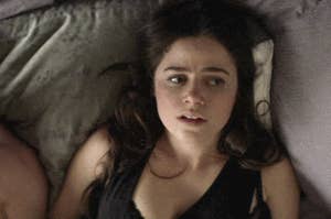 Woman in bed looking unhappy