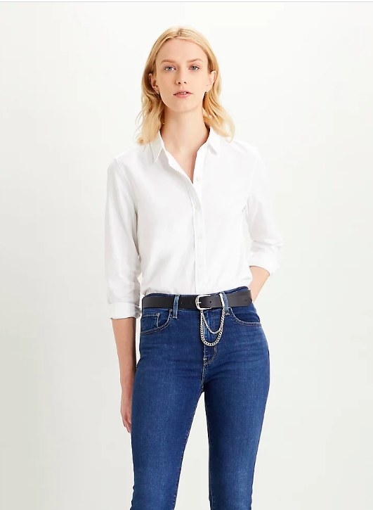 Model wearing the white shirt tucked into jeans