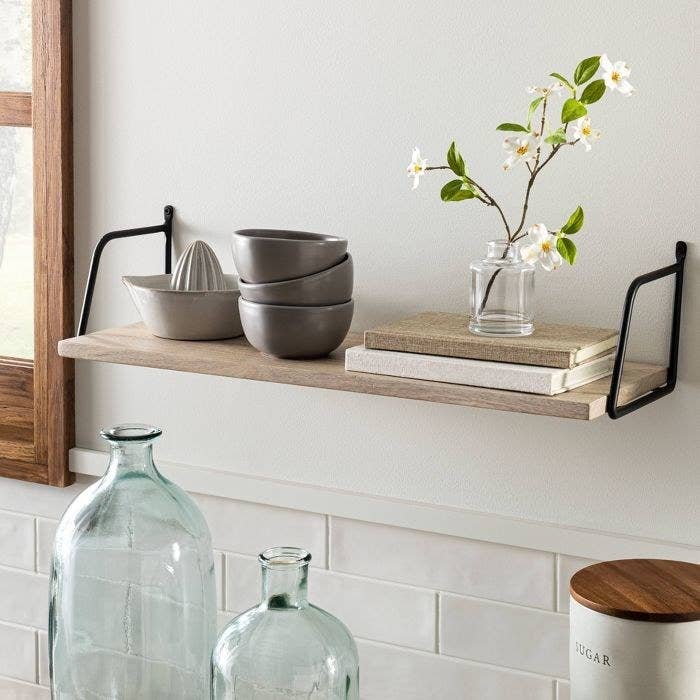 wood and metal shelf on wall