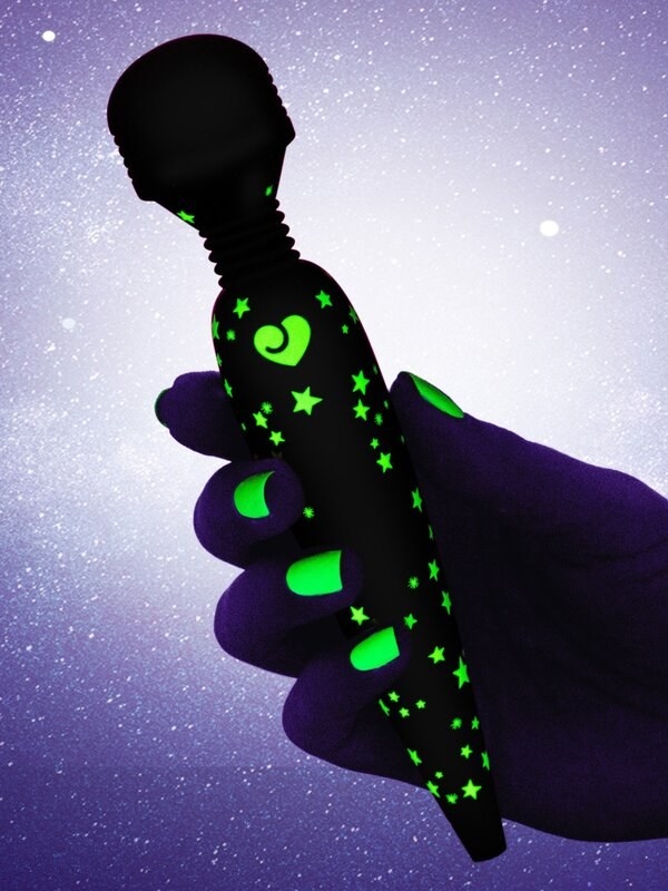 Model holding glow in the dark wand vibrator