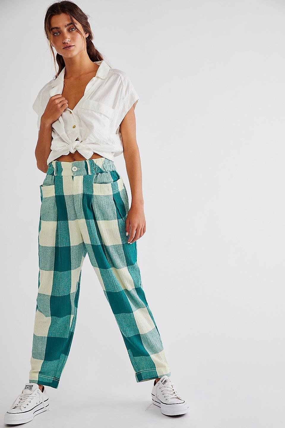model wearing the trousers in teal and white plaid