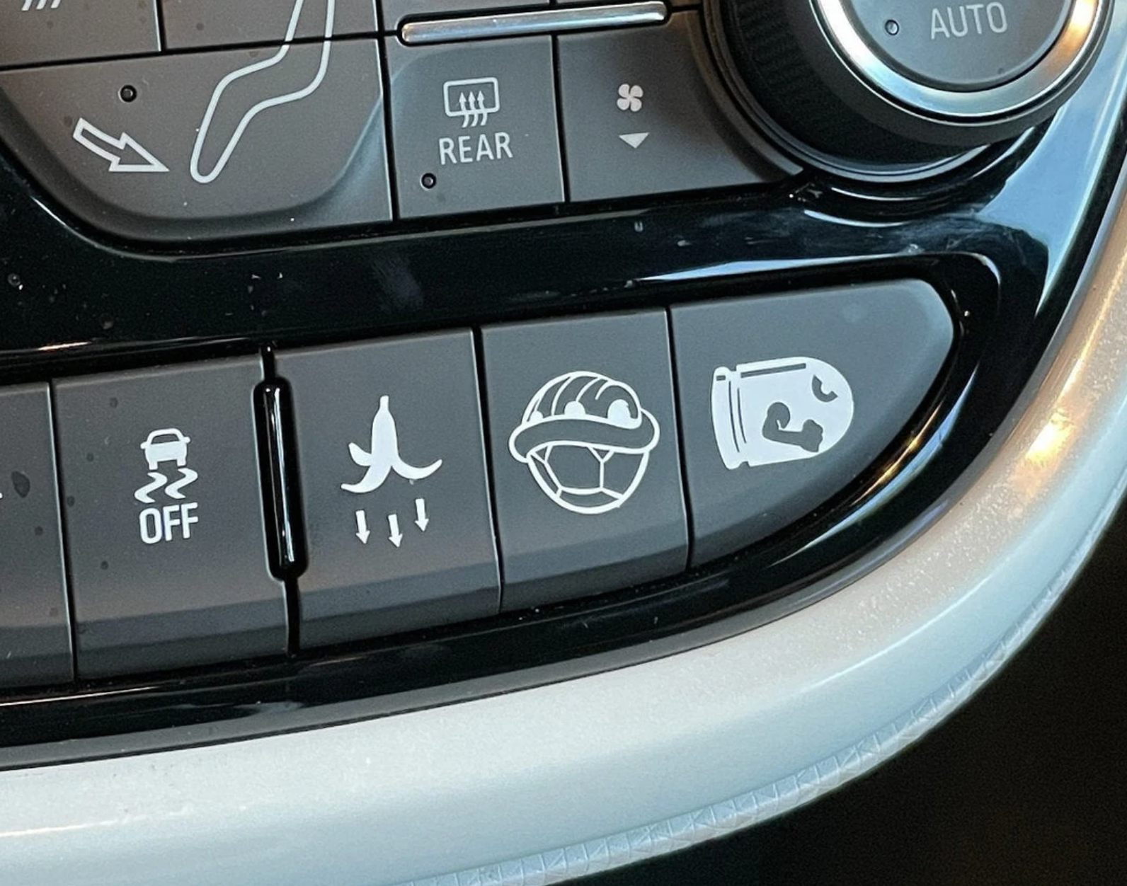 The banana, shell, and bullet decals on a car&#x27;s dashboard buttons