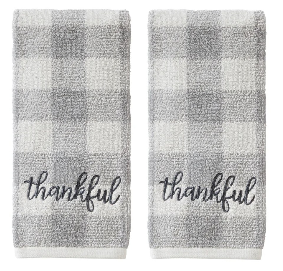 A set of light grey/white plaid hand towels with embroidered "thankful" in cursive on them