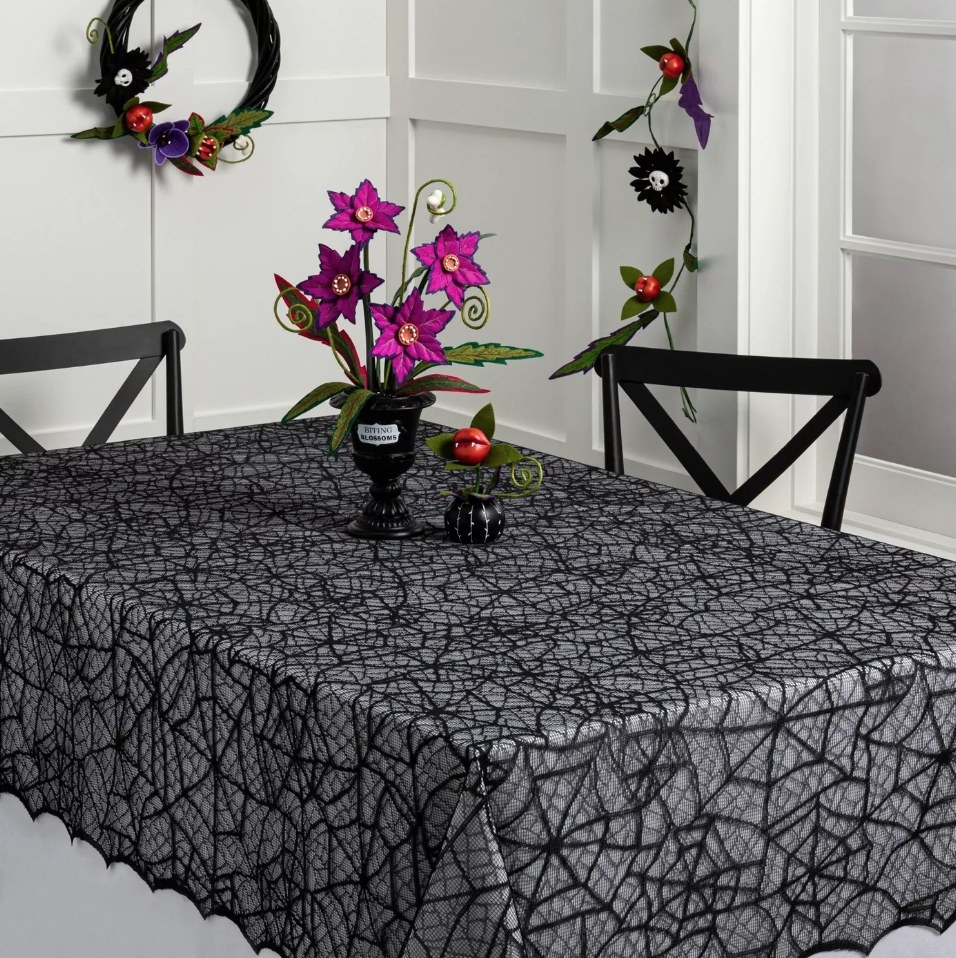 Black lacy cobweb tablecloth on table