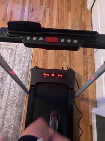 reviewer pov photo running on treadmill, view of readout numbers