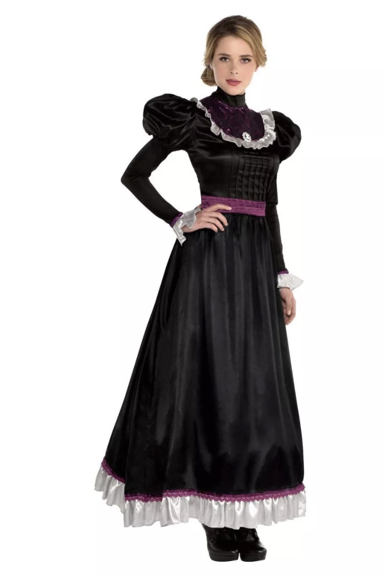 An adult wears a black long dress with puffed sleeves and white and purple ruffle detailing