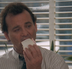 gif of bill murray in groundhog day shoving cake in his face