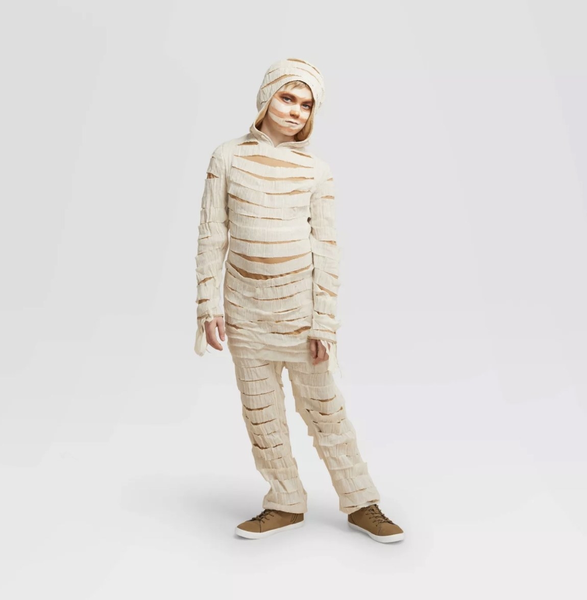 A child wears the ivory-colored bodysuit with white gauze strips