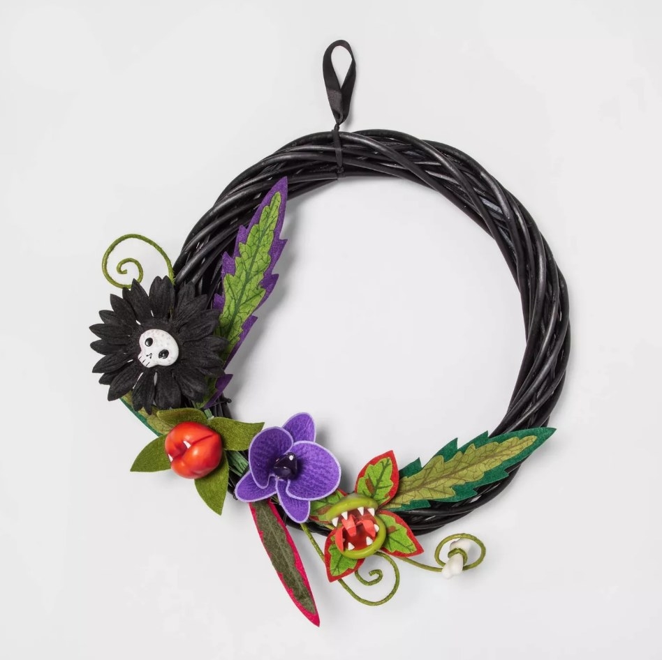Black wreath with black skull flower, venus fly trap, purple flower, and kiss of death flower