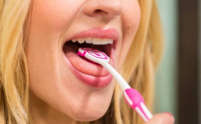 Model using the tongue-cleaning brush