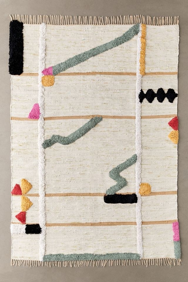 A geometric and tufted rug is shown