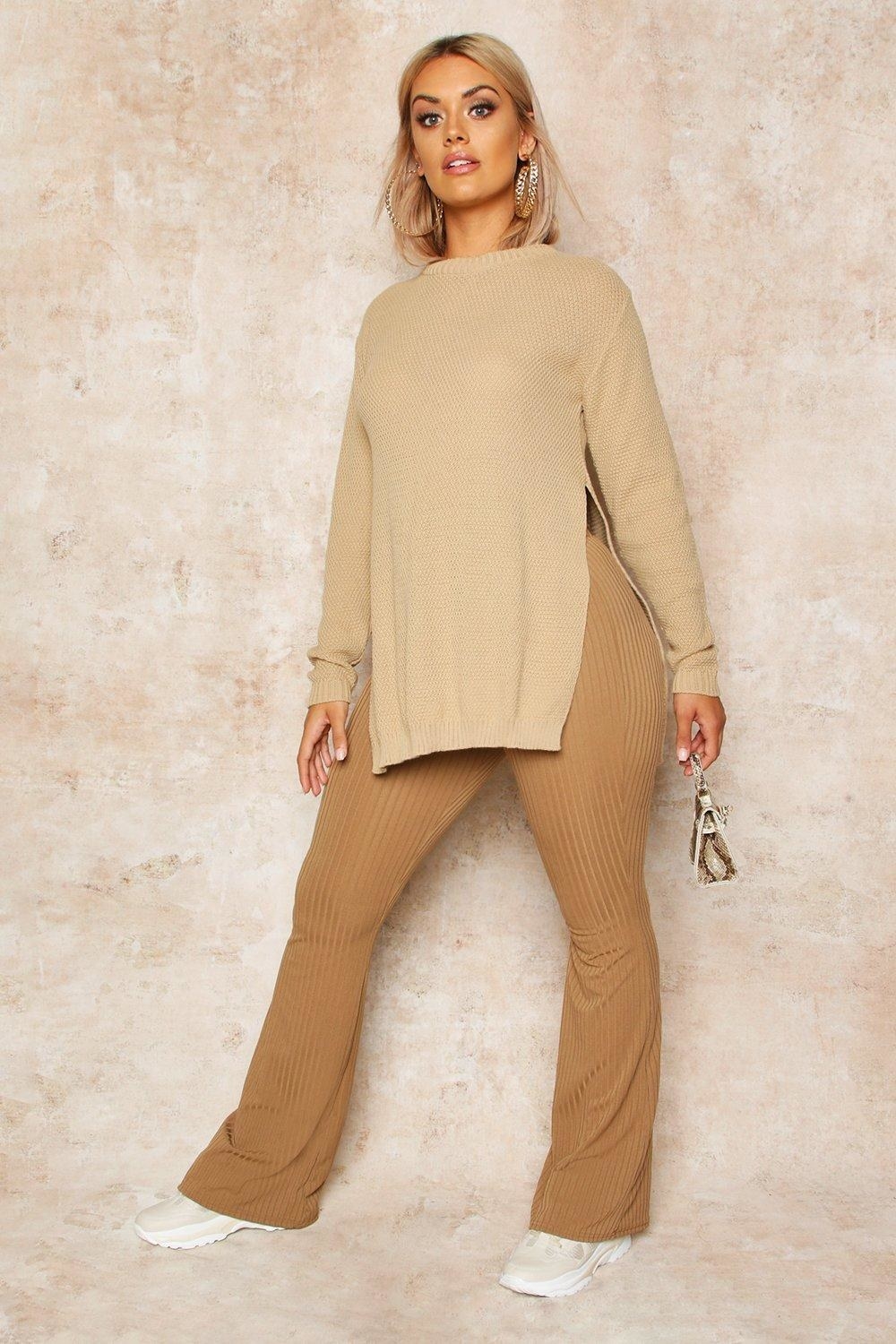 Model wearing brown sweater with slits