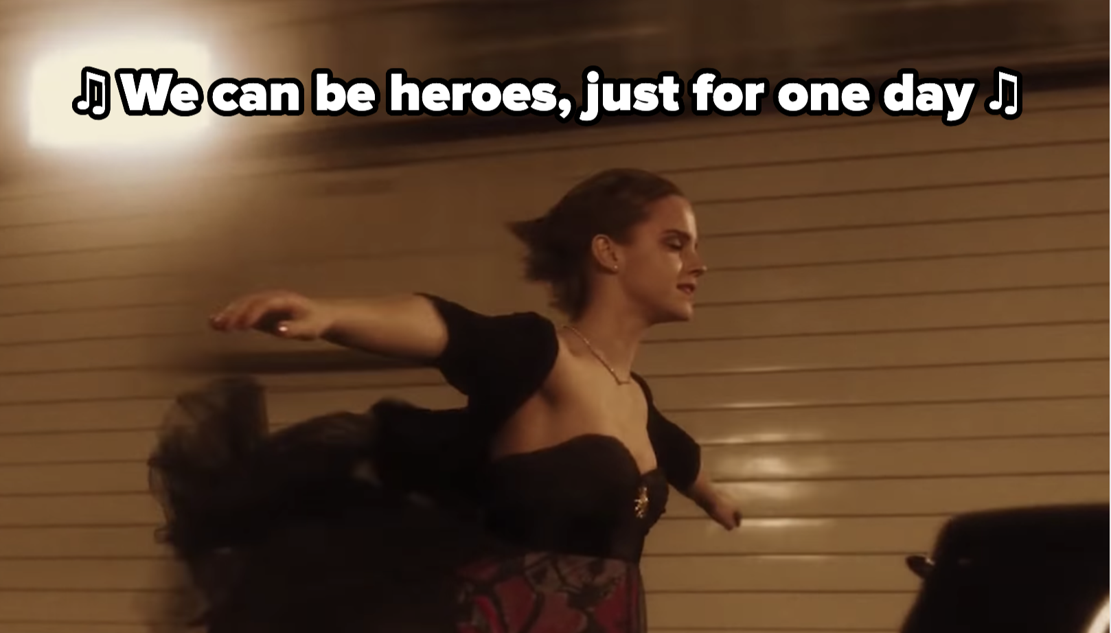 Emma Watson spreads her arms in the tunnel while Heroes plays