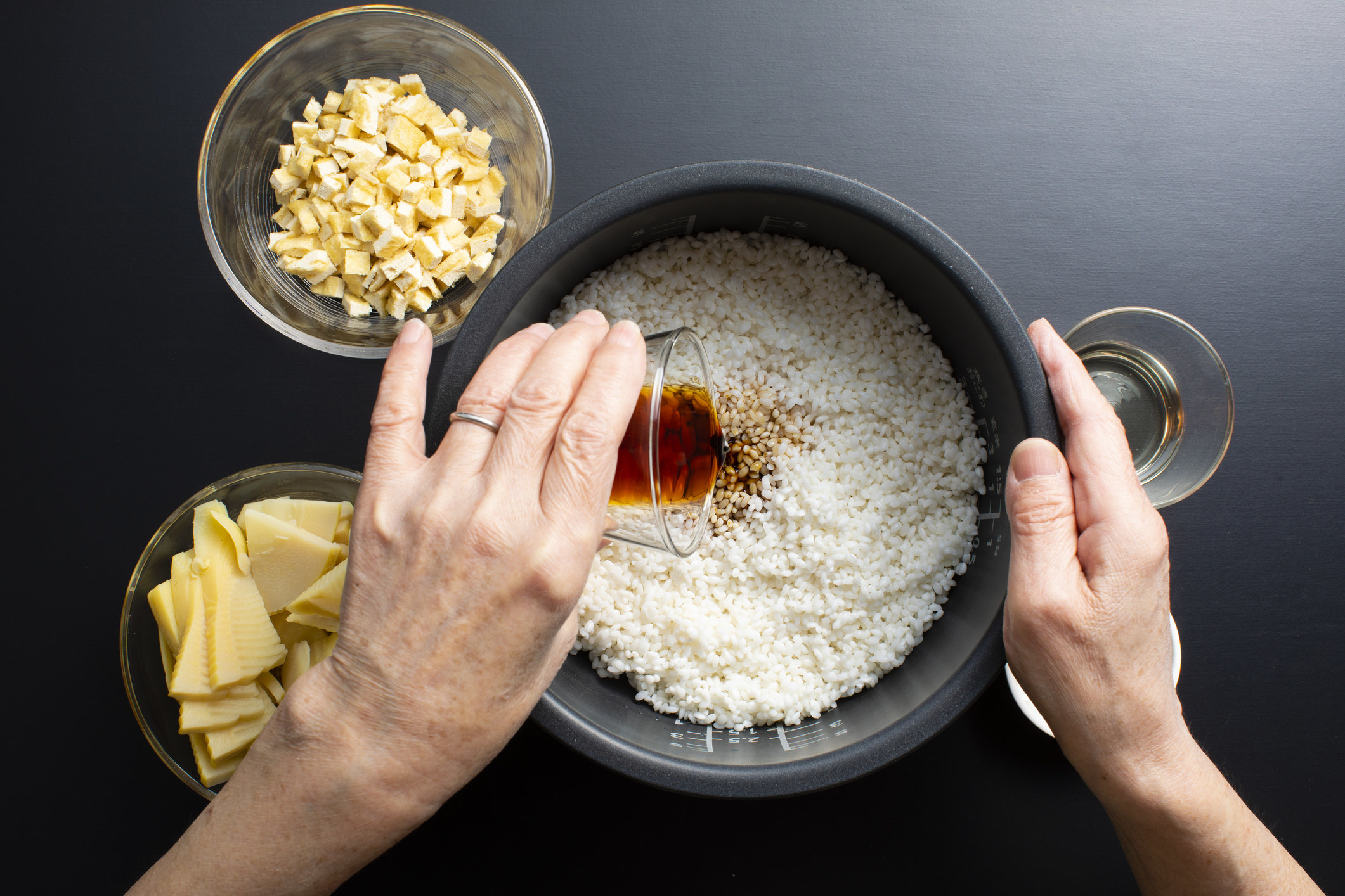 Adding soy sauce to rice.