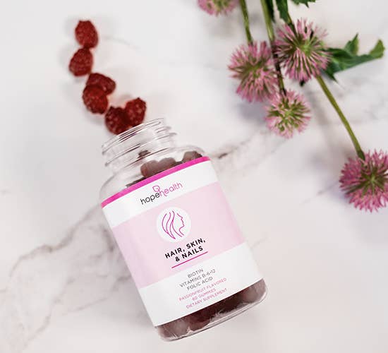 Product of Hope Health Hair, Skin, & Nails gummies on marble counter