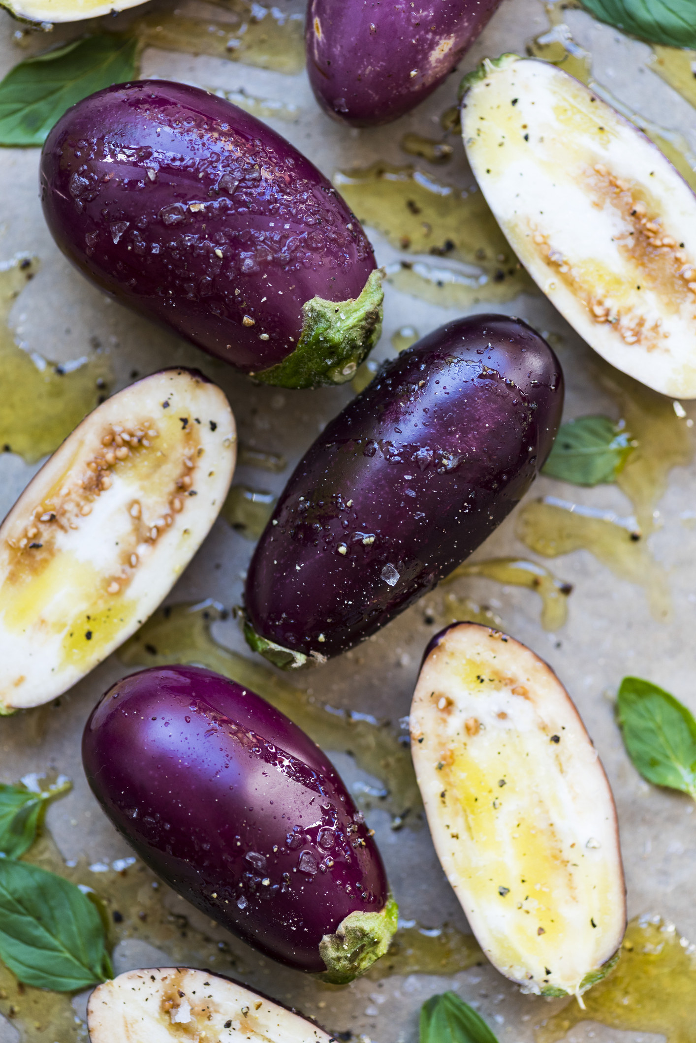 Eggplant halves drizzled in salt, olive oil, and pepper.