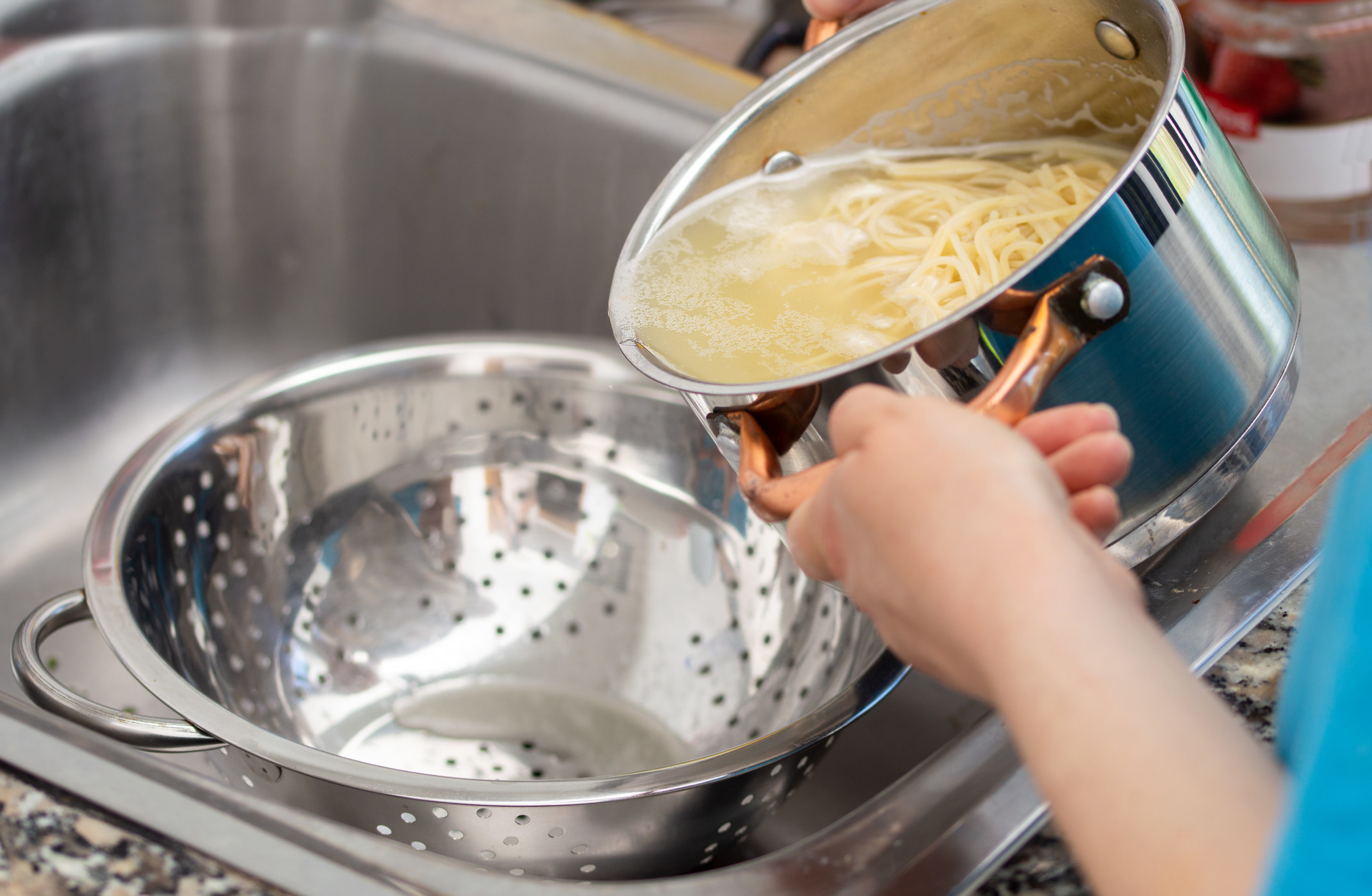 Draining pasta into a collander.