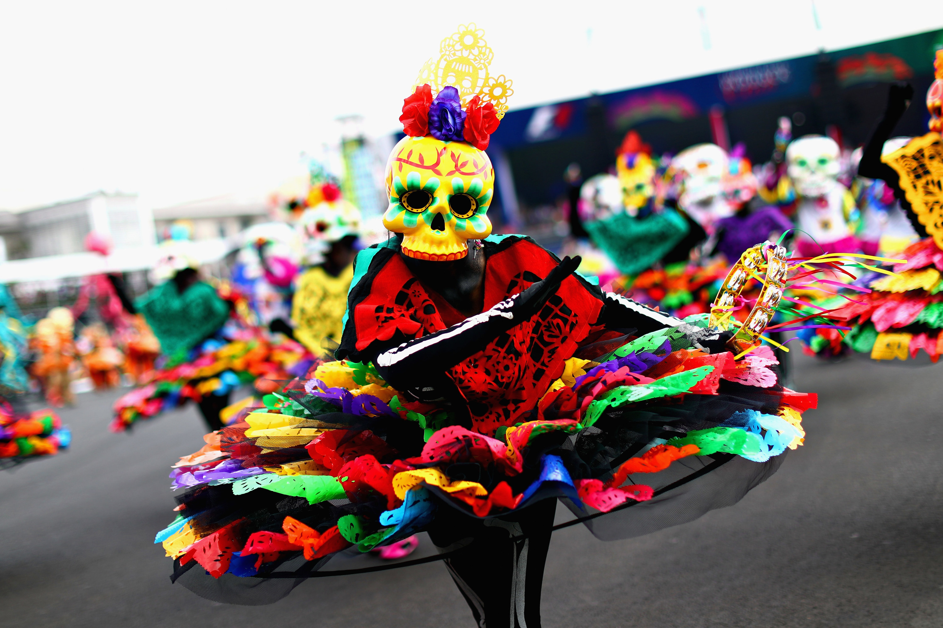 Bright-costumed person wearing skull mask