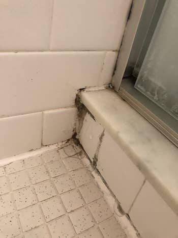 before reviewer image of moldy sealant in a bathroom