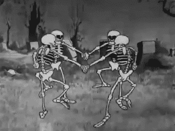 Four skeletons holding hands and dancing in a circle in Disney&#x27;s &quot;Skeleton Dance&quot; short film