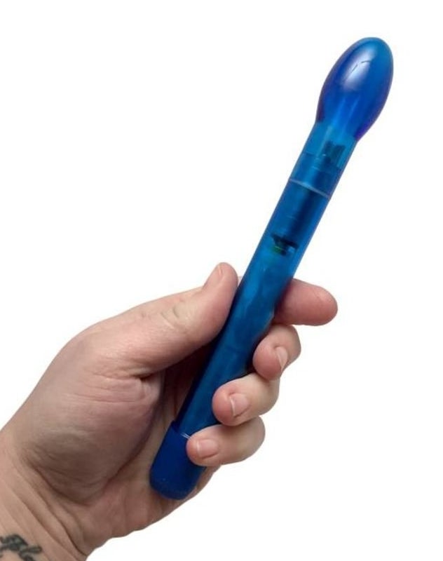 Model holding blue slender wand with bulb at the end