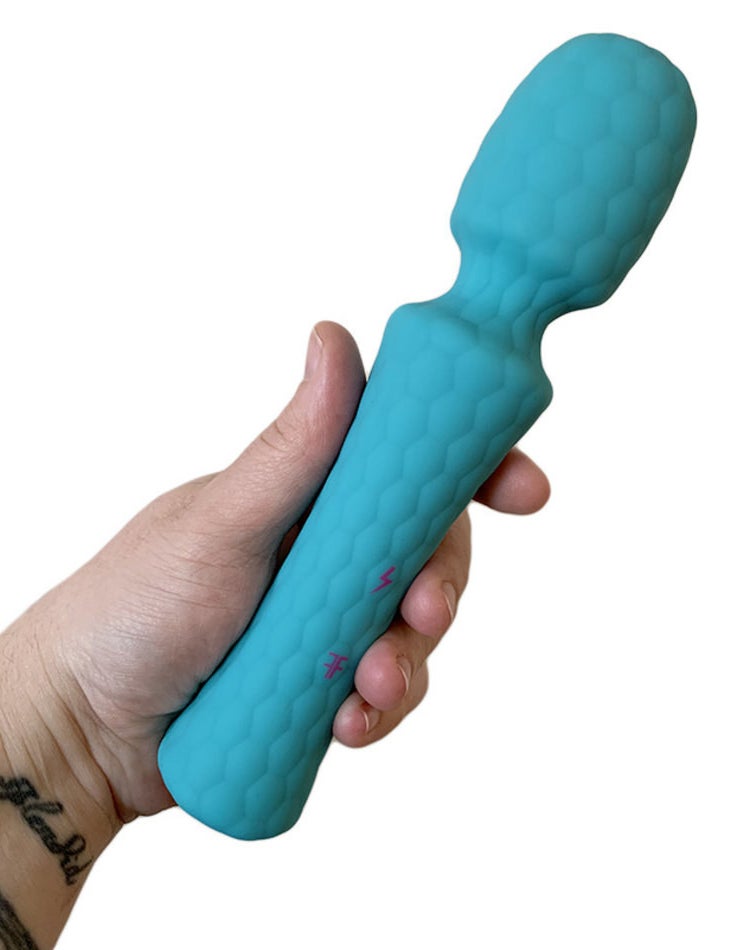 Model holding turquoise textured wand vibrator