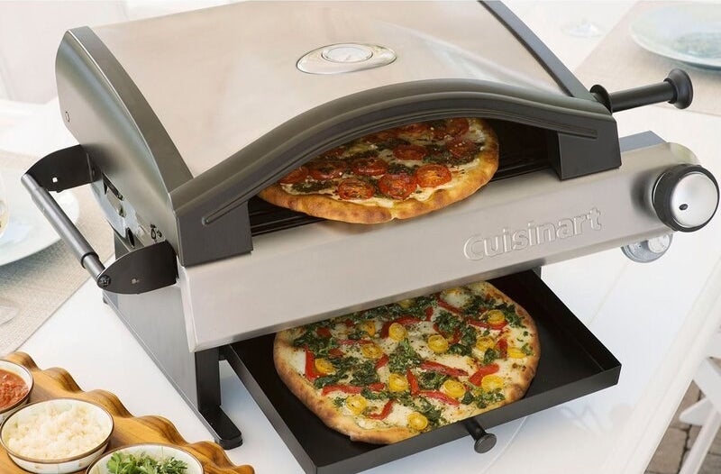 a small pizza oven cooking two pizzas