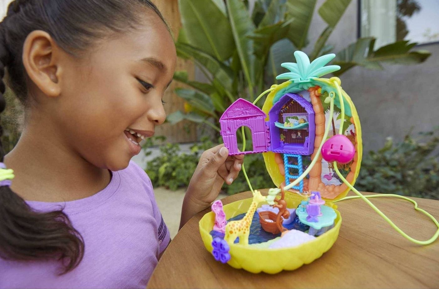 Girl playing with Polly Pocket purse