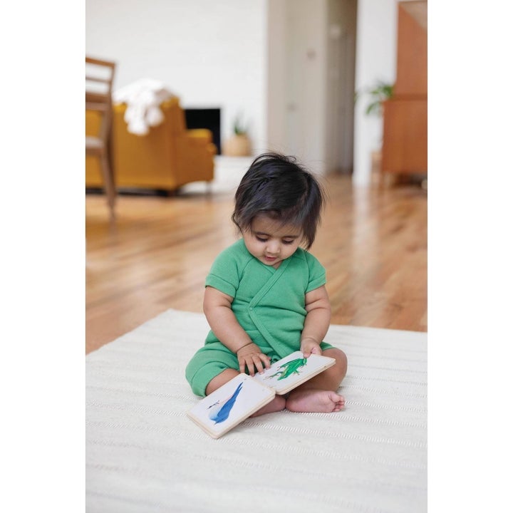 Child reading wood book