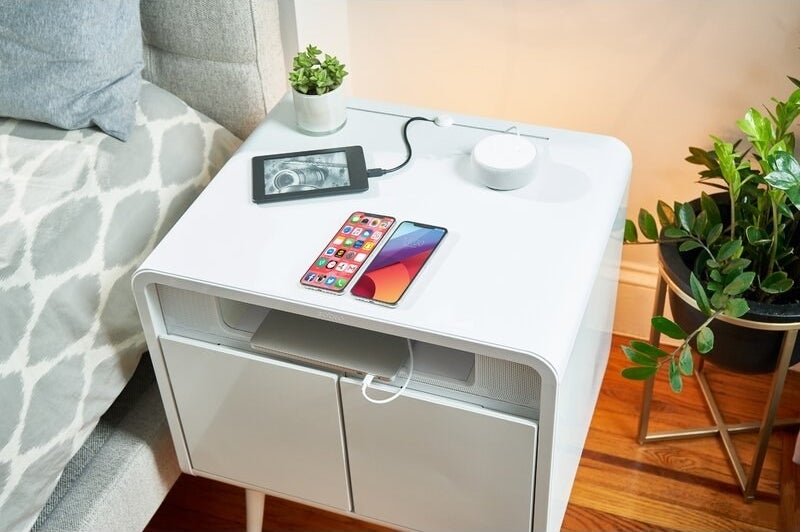 an end table with two cabinets, a slot for a laptop, and USB ports for charging devices