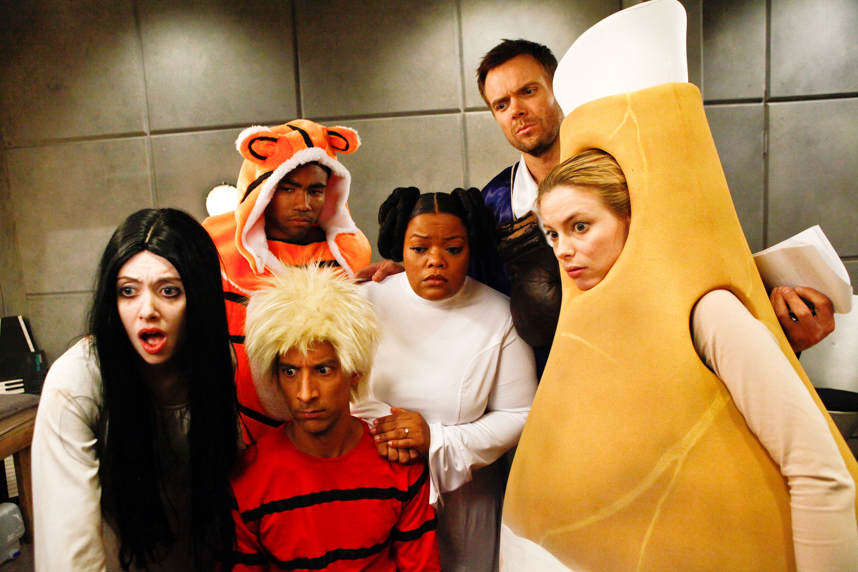 The cast of Community on set in Halloween costumes