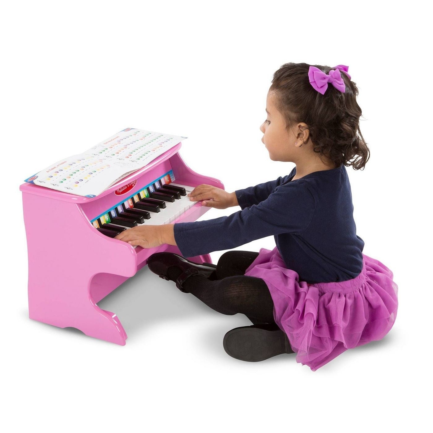 Girl playing a pink piano